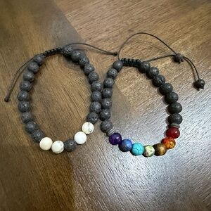 Two lava stone brackets with how lite and 7 chakras energy bracelets